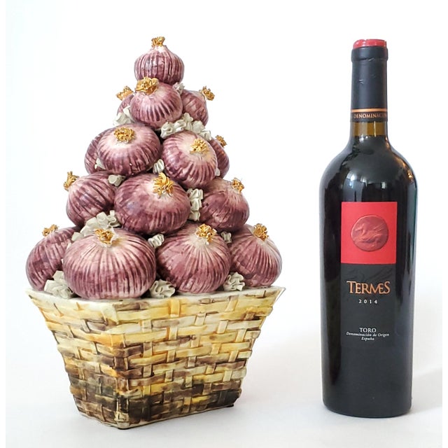 Offering an unusual 1950s Italian porcelain topiary depicting a woven basket filled with a stack of red onions. A one-of-...