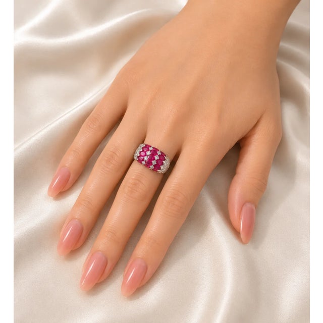 This 14K white gold ring features 15 natural oval rubies totaling 5 carats and 22 brilliant round diamonds totaling 1...