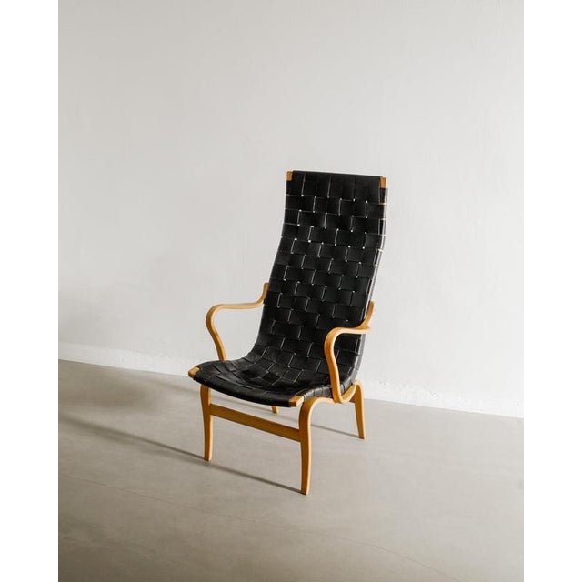 A rare swedish mid century wooden high back armchair by bruno mathsson with a sculptural birch frame and a unusual...