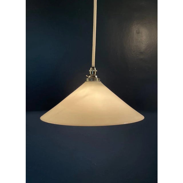 Circa 1910 truncated conical opaline suspension, series available. This pure white suspension lamp with the inimitable...