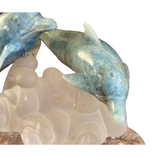 A finely carved aquamarine and rock crystal sculpture of two dolphins by renowned German lapidary artist Manfred Wild,...