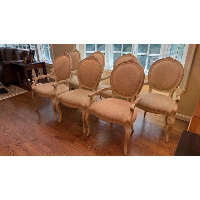 This elegant set of seven Louis XVI-style dining chairs features seven armchairs and one side chair, each showcasing...