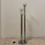 Vintage 1970s floor lamp in true Space Age style, featuring three chromed metal stems of varying heights mounted on a...