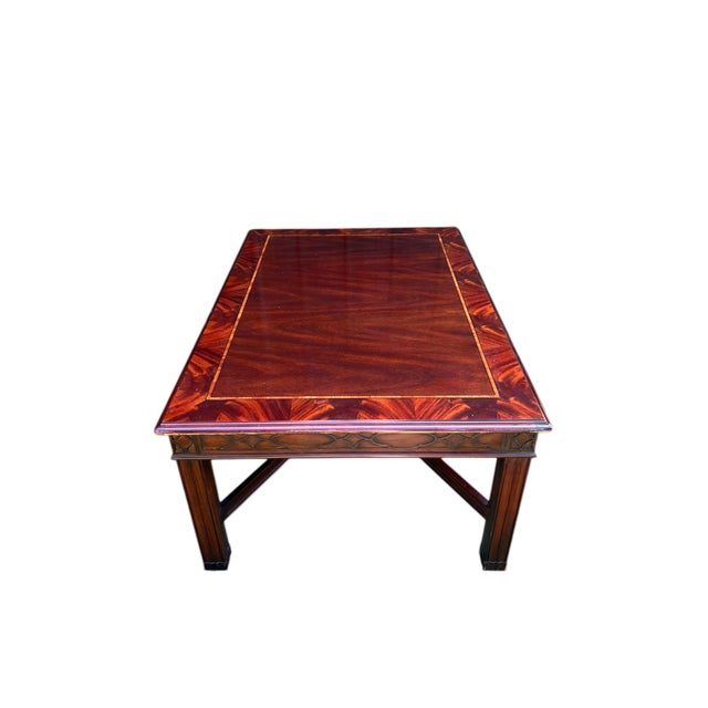 A beautiful coffee or occasional table by Henkel Harris in banded flame mahogany and satinwood or tulipwood inlay, with...