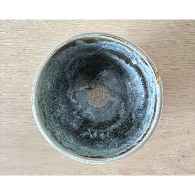 A small American studio pottery bowl made in New York, with a softly rounded hand-thrown form and a beautifully variegated...