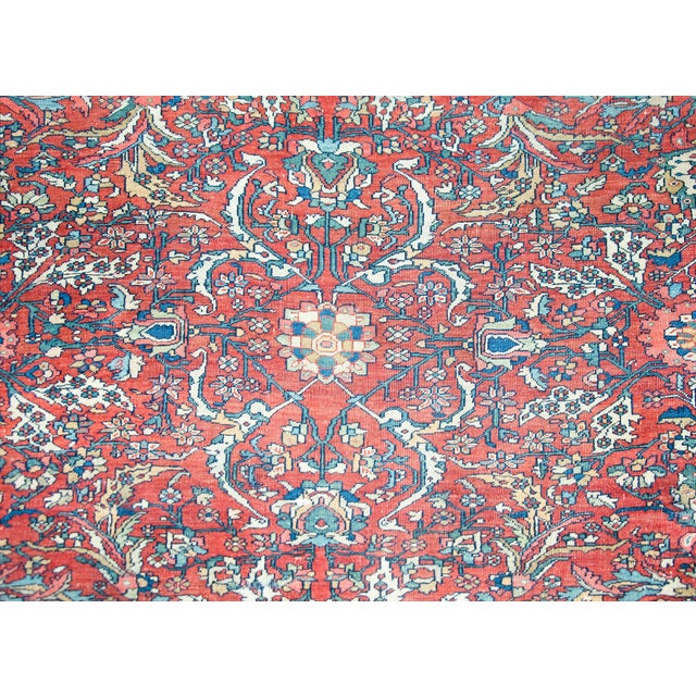A stunning late 19th century Persian Sarouk Farahan rug with an all-over mirrored trellis floral and scrolling vine...