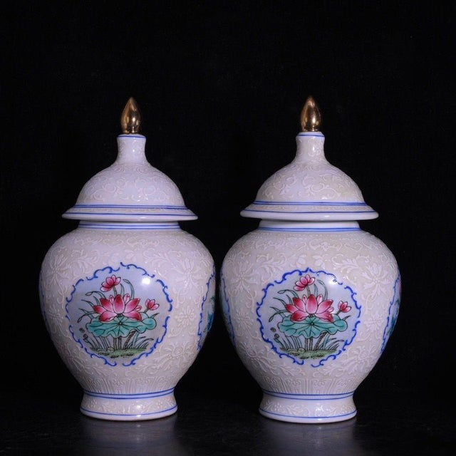 A beautiful pair of Chinese white glazed porcelain covered jars. The body features a subtle, intricately incised (anhua)...