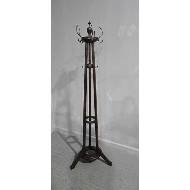 A very nice Arts and Crafts oak coat stand, with brass coat hooks, finial to the top, revolving top, in very good overall...