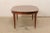 A French Neoclassical style table dining table. This vintage table from France has an oval-shape with an oval inlay...