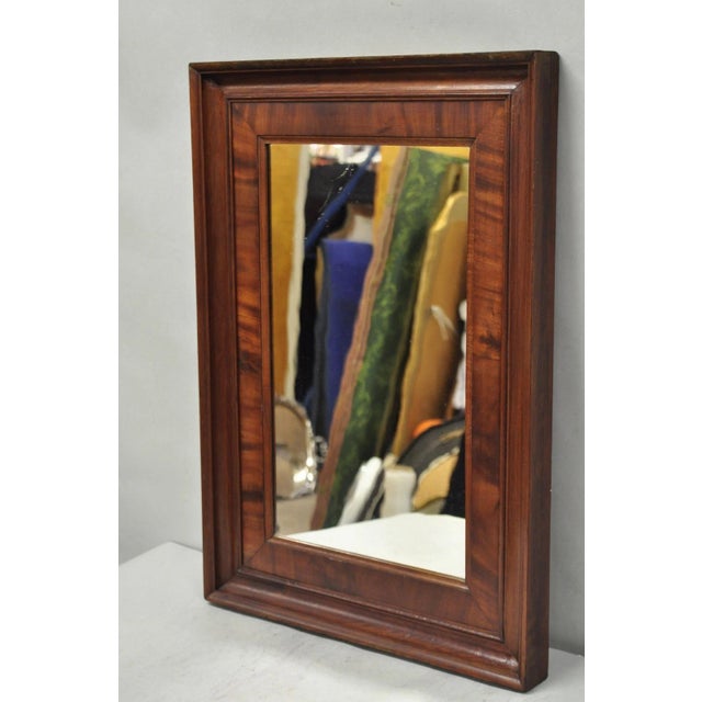 Antique American Empire Crotch Mahogany Wood Frame Rectangular Wall Mirror. Circa Late 19th Century. Measurements: 27" H x...
