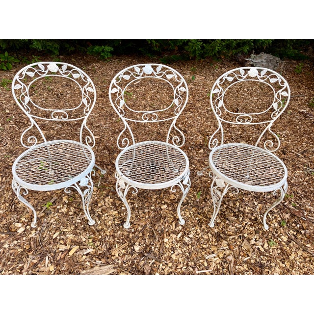A beautifully intact set of three Woodard Chantilly Rose wrought iron side chairs in all-original condition — a...