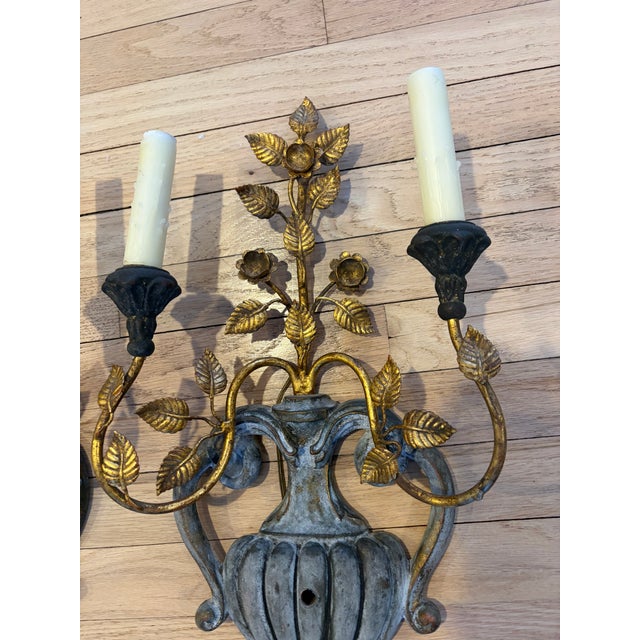 Pair of mid century Palladio wall sconces. Beautiful gold leaves and flowers extend from a vase with gorgeous patina. Very...