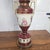 Vintage Fragonard-Style Porcelain Urn Lamp in Burgundy & Gold Gilt This monumental 31" table lamp presents a sophisticated...