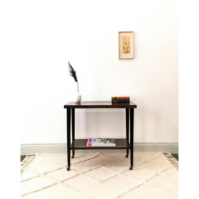 This rolling side table dates from the 1950s and was made in Germany in the typical, minimalist style of the Bauhaus era....