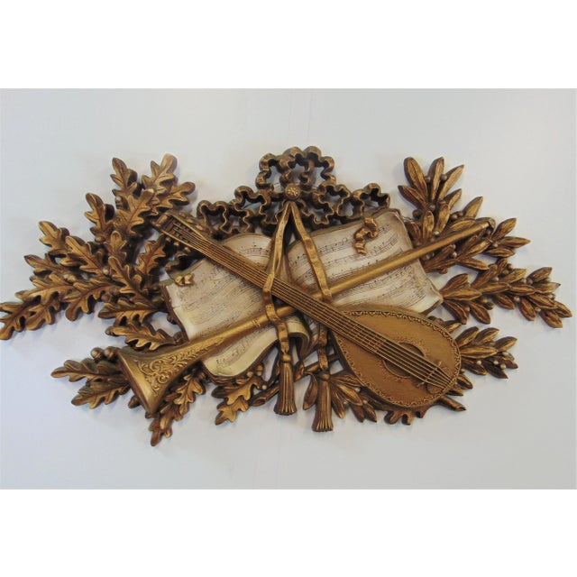 Mid Century Italian style musical themed wall art. made of plastic resin. It is comprised of 2 musical instruments over a...