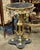 An exquisite French Rococo accent table featuring a luxurious black marble top, elaborate gilded bronze framework, and...