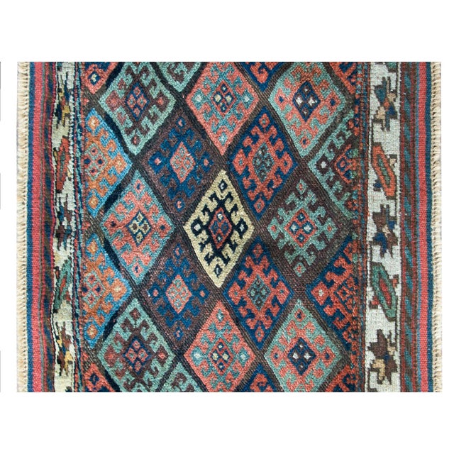 A wonderful early 20th century Kurdish Jaffe rug with a central field with several multi-colored stylized floral patterns,...