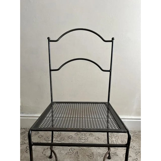 Vintage steel chair from France, c.1950. Handmade and featuring curves to the back, legs and struts and a perforated sheet...