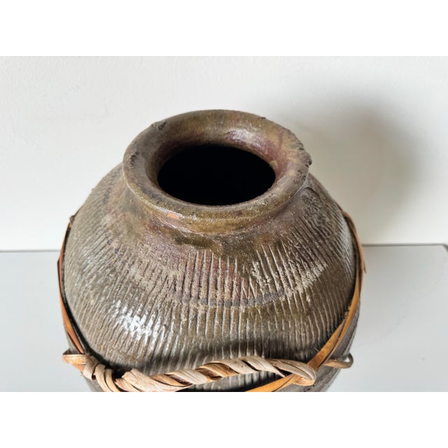 This large vintage vase from the 1980s exudes rustic charm with its handcrafted design. Made from durable clay, it...