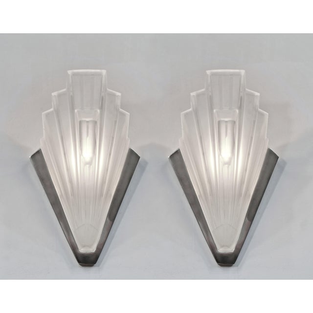 SABINO A pair of 1925-1935 French art deco wall sconces by Marius Sabino. Nickel plated solid brass or bronze mounts hold...