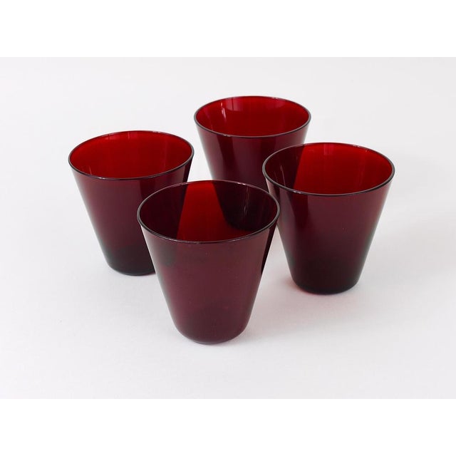 A set of four fine Kartio drinking glasses in rare red glass from the 1950s. Designed by Kaj Franck, executed by...