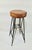 An original industrial stool/bar stool from the mid-20th century, made of steel and a thick, natural leather seat with...