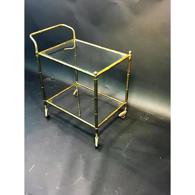 Decorative double tiered brass bamboo bar cart with glass shelves.nicely detailed brass ball accents decorate the corners...