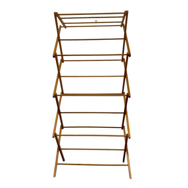 This vintage folding clothes drying rack features a tall, multi-tier, accordion-style frame designed to provide generous...