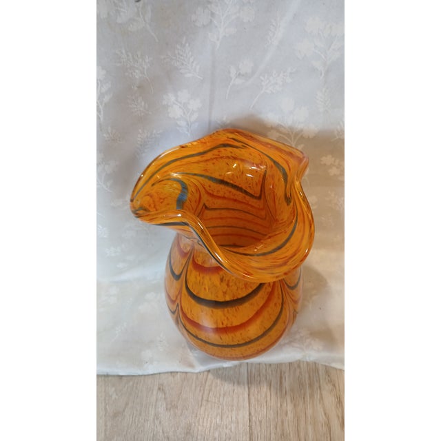 An exceptional mid-century modern hand-blown cased art glass vase, masterfully executed in a vibrant Murano style. This...