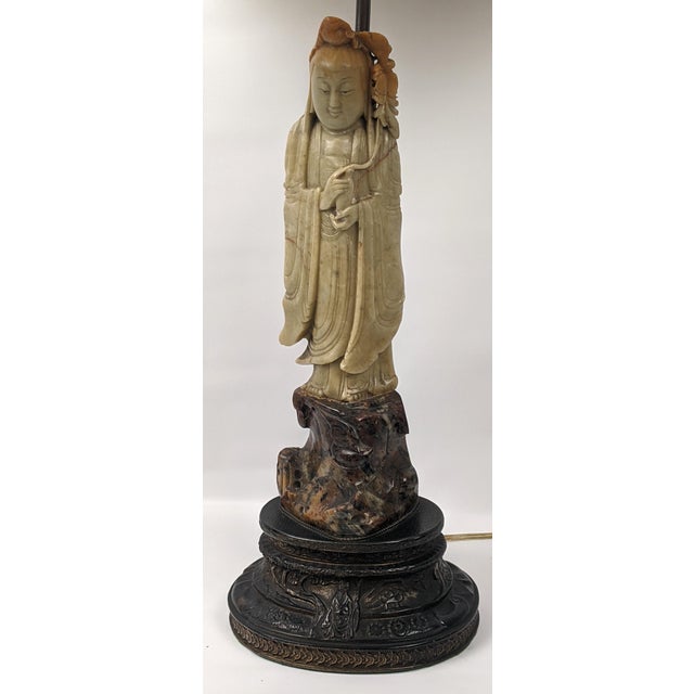 A serene vintage Chinese table lamp centered upon a hand-carved soapstone figure of Guanyin, the bodhisattva traditionally...