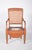 Potty chair with straw back. In light wood, with a hollowed-out seat and a central opening where a crockery container...