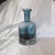 This is a large decanter by Block in Festival Teal. The decanter is teal color glass with a clear base with a bubble in...