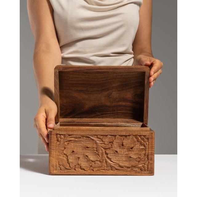 This 20th century hand-carved wood jewelry box from France is carved in honey-toned wood with a dense foliate relief on...