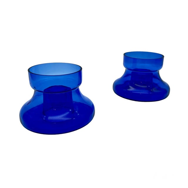 Unique bubbled candlestick holders made of cobalt blue-colored glass.