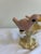 A delightful vintage cast iron bird feeder featuring two hand-painted pink birds perched on either side of a scalloped...