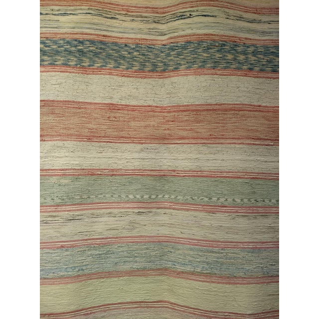 A beautiful and extremely rare near-square format American rag rug from the late 1800s — the square proportion itself a...