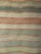 A beautiful and extremely rare near-square format American rag rug from the late 1800s — the square proportion itself a...