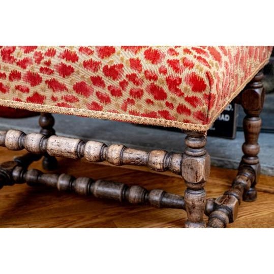 Beautifully crafted vintage footstool. Featuring a richly patterned upholstered seat in warm red and cream tones, this...