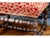Beautifully crafted vintage footstool. Featuring a richly patterned upholstered seat in warm red and cream tones, this...