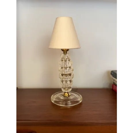 Handcrafted in Murano, Italy during the 1950s, this small elegant table lamp features a stacked column of mould-blown...