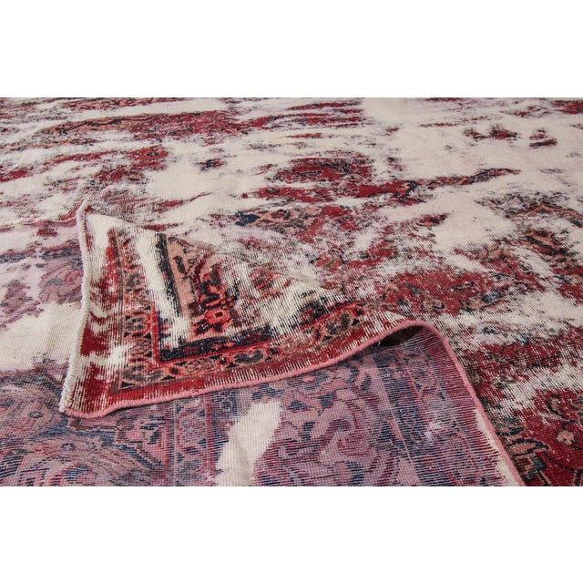 A hand-knotted Overdyed rug with an allover design. This rug measures 8'10" x 12'5".