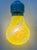Blown glass pendant in the shape of a light bulb, with solid yellow murrines cast by master glassmakers for a touch of...