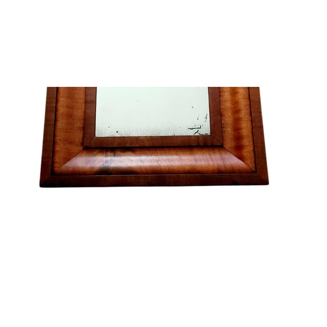 This antique American Empire flame mahogany ogee wall mirror dates back to the 1820s to 1850s. The frame features a ogee...