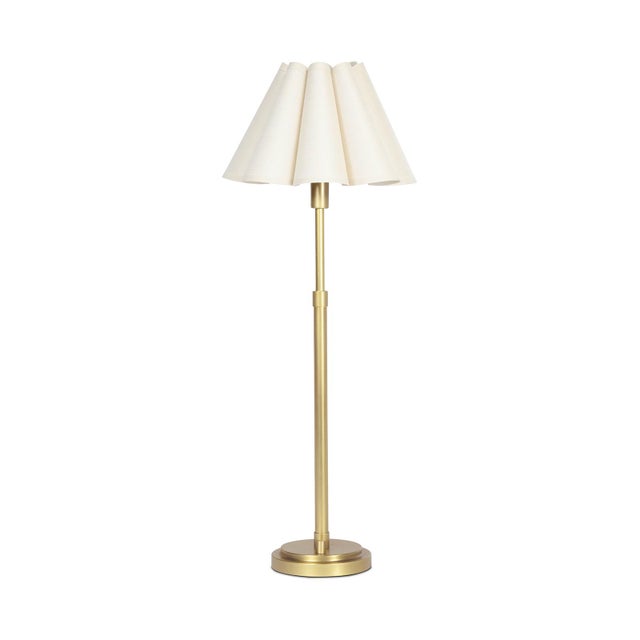 The Polly Buffet Table Lamp showcases sophistication with its single scalloped shade, casting a warm and inviting glow...