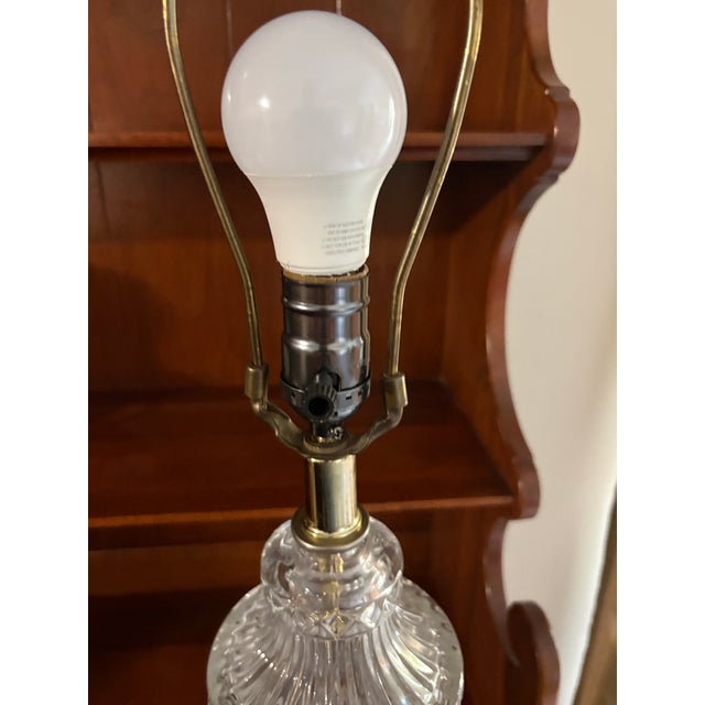Vintage clear pressed-glass table lamp with an elegant diamond-and-fluted glass pattern, brass-tone metal base, and harp-...