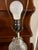 Vintage clear pressed-glass table lamp with an elegant diamond-and-fluted glass pattern, brass-tone metal base, and harp-...