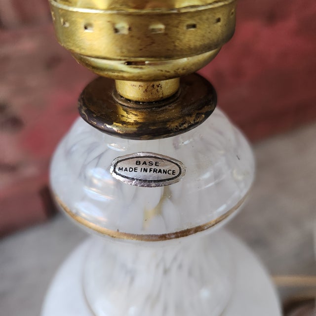 These vintage French table lamps feature delicate handcrafted gold floral designs on a white glass base. Their antique...