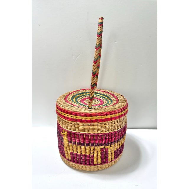A beautiful handwoven Peruvian lidded basket featuring vibrant colors and traditional weaving techniques. Pieces like this...