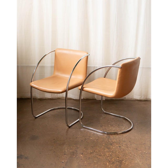 Clean, sculptural, and unmistakably Italian, this set of Saporiti chairs pairs sleek chrome frames with supple saddle...