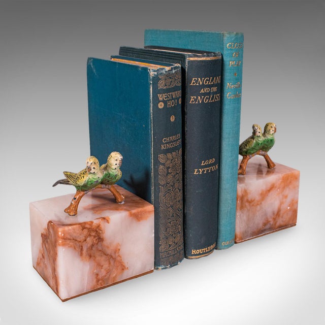 This is a pair of vintage budgerigar bookends. An Italian, cast metal and onyx marble budgie novel rest, dating to the mid...